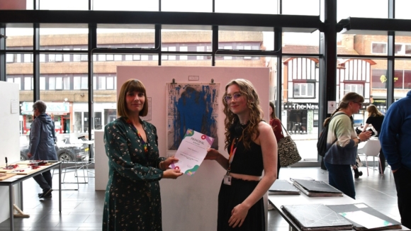 Photograph - L-R Kelly Rinaldi, Principal at Barnsley Sixth Form College presenting a certificate to A Level Art and Design student Emily Arnold